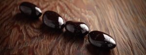 a close-up of rich, dark cacao beans arranged artistically on a sleek, polished wooden surface, accentuated by soft, warm lighting to highlight their texture and color, conveying the essence of luxury in chocolate making.